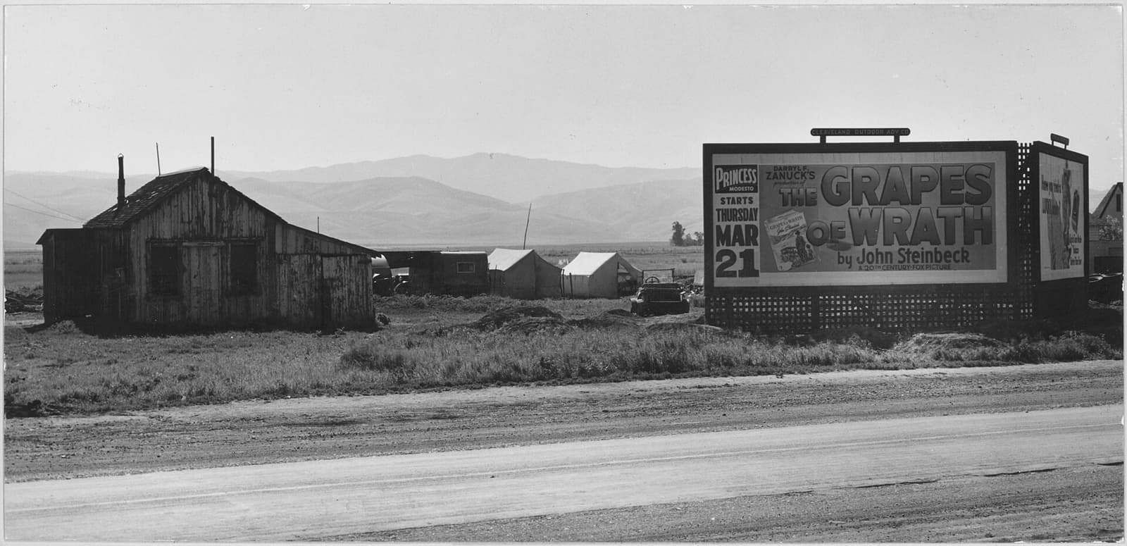 A bought billboard standing beside a California highway in 1940, advertising a film to everyone who passes